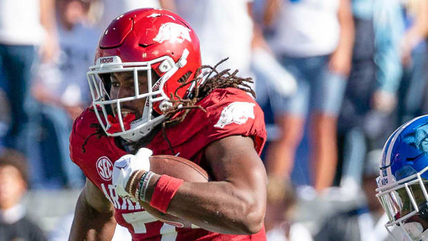 Arkansas Razorbacks tight end Trey Knox runs just out of reach of Brigham Young University cornerback Mandell D Angelo in the first half as the Razorbacks face the Cougars at LaVell Edwards Stadium.